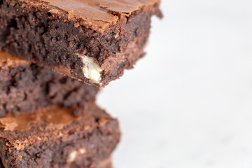 brownies chocolate three stacked on white background extreme close up