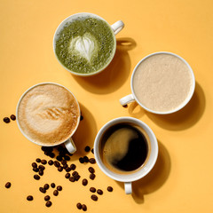 Top view Creative americano cappuccino latte art coffee and hot matcha so delicious in hard light on colorful yellow background. Coffee cup assortment collection with hard shadow