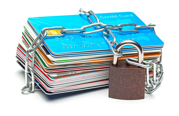 Stack of credit cards and a padlock with chain isolated on a white background. Closed access to...