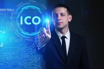Business, Technology, Internet and network concept. Young businessman working on a virtual screen of the future and sees the inscription: ICO