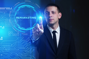 Business, Technology, Internet and network concept. Young businessman working on a virtual screen of the future and sees the inscription: Remarketing