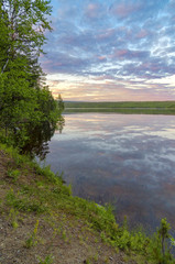 Dramatic summer sunset and pines at Tuloma river, Kola Peninsula, Murmansk region, Russia