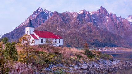 Small church on the background of evening mountains on the Lofoten islands in Norway