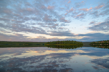 Fototapeta premium Dramatic summer sunset and pines at Tuloma river, Kola Peninsula, Murmansk region, Russia