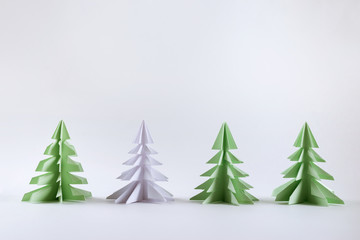 Christmas concept. Origami paper green Christmas trees.