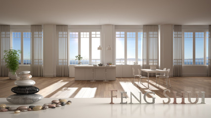 White table shelf with pebble balance and 3d letters making the word feng shui over white kitchen with dining table and big panoramic window, zen concept interior design