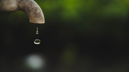 Tap water drop close up outdoor.