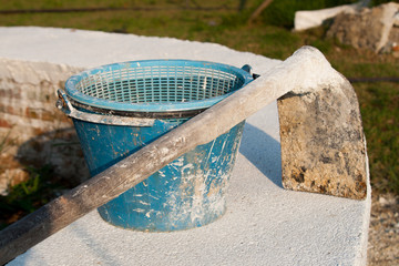 construction blue bucket and  hoe