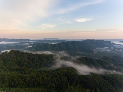 Aerial Drone image of beautiful Misty And Foggy dew during early morning sunrise at beautiful rainforest Sabah, Borneo