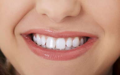 White teeth. Beautiful smile of woman with whitening teeth. Dental and oral care.