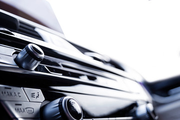 Media and navigation control buttons of a Modern car. Car interior details. White leather interior...
