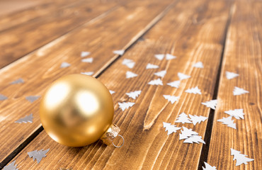 gold christmas ball on a wooden background