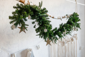 Modern interior design room with Christmas and New Year decorations, toys, gifts, fir tree, hanging swing. Winter holidays composition.