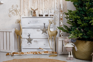 Modern interior design room with Christmas and New Year decorations, toys, gifts, fir tree, hanging swing. Winter holidays composition.