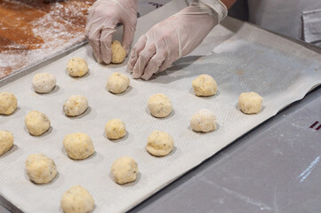 making Brazilian cheese bread pao di Kejo, making dough. Dough placed on a baking sheet. Pao de Kizho