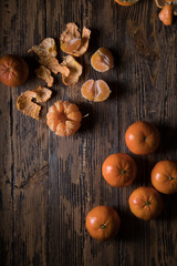 Orange or mandarin on wooden dark background. Winter mood.