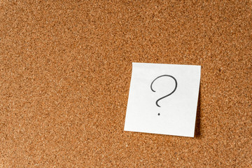 Question mark on sticker on cork board, Background, copy space.