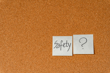 Security issue, paper stickers on cork board. Safety concept in office work. Background.