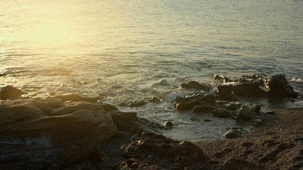 Fantastic view of the seashore at sunset. Easy soft light falling on rocks and water. Sunset over sea