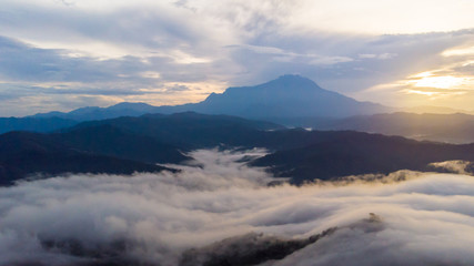 Fototapeta na wymiar Rural landscape with dramatic sea of cloud during sunrise with Mount Kinabalu at Saba, Borneo
