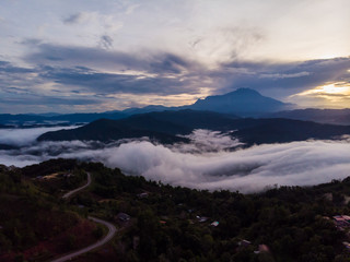 Rural landscape with dramatic sea of cloud during sunrise with Mount Kinabalu at Saba, Borneo