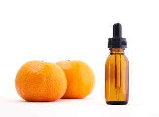 Oranges and bottle with essential oil, Vitamin serum in the bottle and Oranges on white background