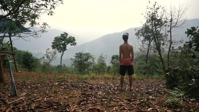 Slowmotion of Young Blond Male Looking at the View of the Mountains in Thailand