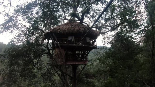 POV of Male Ziplining Towards and Arriving in a Treehouse during the Gibbon Experience in Laos
