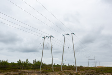  Transmission towers (power tower, electricity pylon, steel lattice tower) cloudy sky. High voltage pillar, overhead power line, industrial background.