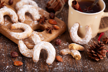 Cookies in a shape of horseshoe covered with sugar powder. Delicious biscuits with almonds and hazelnuts. Sweet Christmas dessert.