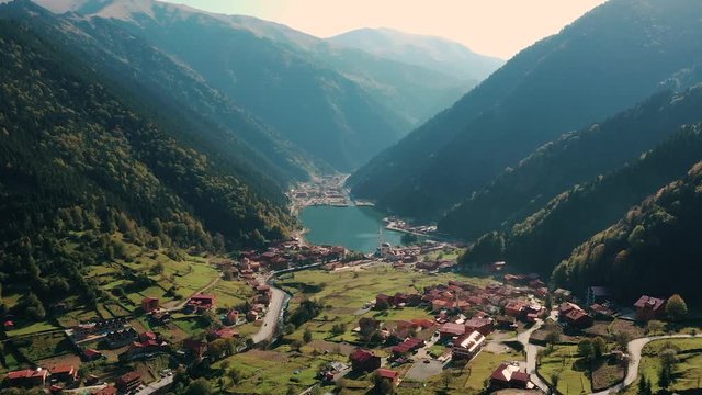Mountain lake with turquoise water and
green trees. Reflection in the water.
Beautiful spring landscape with mountains forest and lake. Aerial View. Drone shot
over a beautiful mountain forest lake
