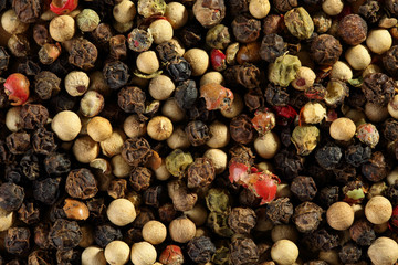 Extreme close up of multicolored peppercorn mix. Macro texture food background
