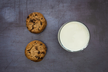 Milk cookies biscuits chocolate chip top view dark background