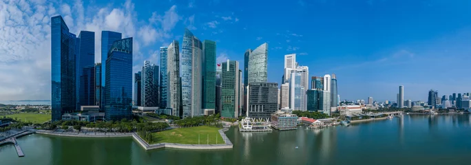 Fotobehang High rise office towers of the Singapore central business and financial district aerial panorama on a sunny morning including waterfront and reflection © Paul