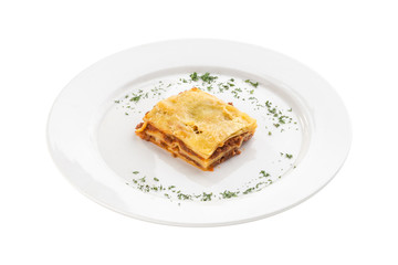 Piece of homemade Lasagne with beef isolated on white background
