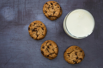 Milk cookies biscuits chocolate chip top view dark background