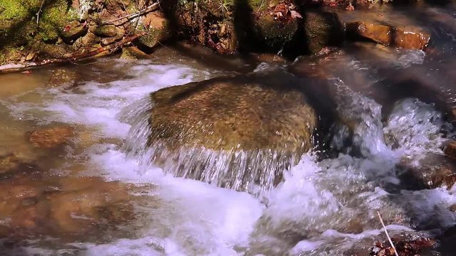 Small stream with cascade over rock