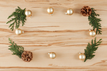 Flat background with wooden desk board top with christmas decorations and ornaments.