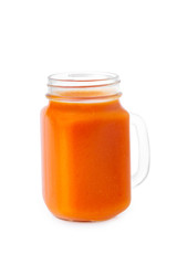 Closeup glass jar of carrot juice isolated at white background. Concept of healthy vegan food