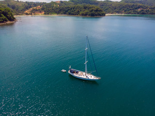 Aerial view of white Yacht in deep blue sea with beautiful landscape view in Kuala Abai, Kota...