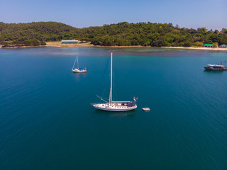 Aerial view of white Yacht in deep blue sea with beautiful landscape view in Kuala Abai, Kota...
