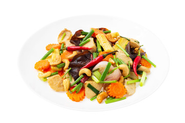 Closeup plate of traditional thai food - stir fried chicken with cashew nuts isolated at white background.