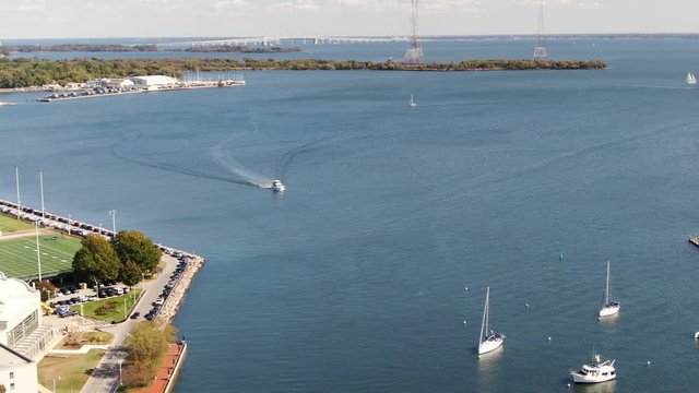Aerial pan of Spa Creek, Severn River, boats, yachts, Naval Academy fields, bridge