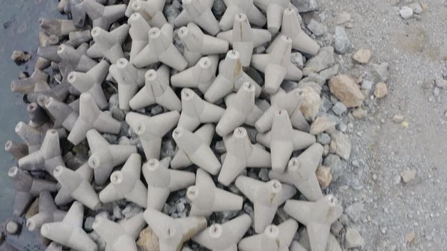 Top View Over  A Line Of Concrete Wave Breakers