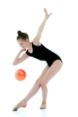 Fototapeta na wymiar Girl gymnast performs exercises with the ball.
