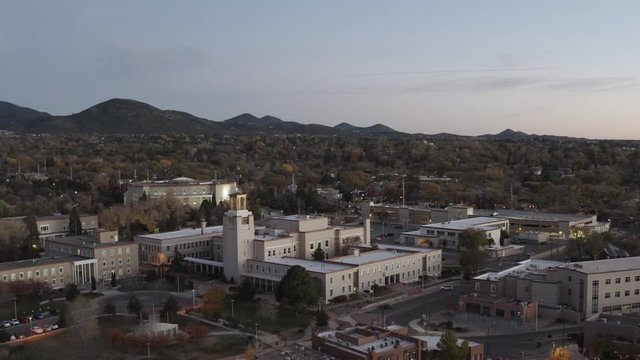 Drone shot flying over the buildings of Sante Fe, New Mexico during Golden Hour.