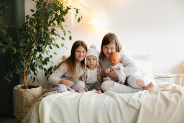 Three children in bed, bright comfortable bedroom