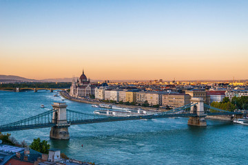 Obraz premium Budapest, Hungary - October 01, 2019: View of the Szechenyi Chain Bridge over Danube and the Hungarian Parliament Building in Budapest, Hungary