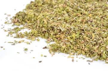 a pile of dried oregano on a white background