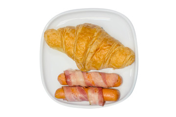 Butter croissant and sausage bacon wrap, focus selective